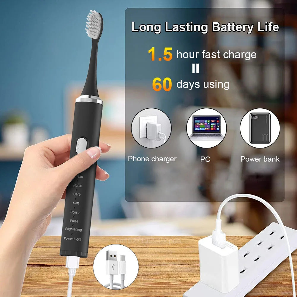 Black electric toothbrush with charging cable on a blurred background