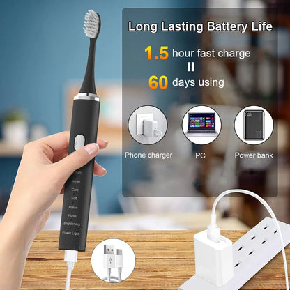 Black electric toothbrush with charging cable on a blurred background